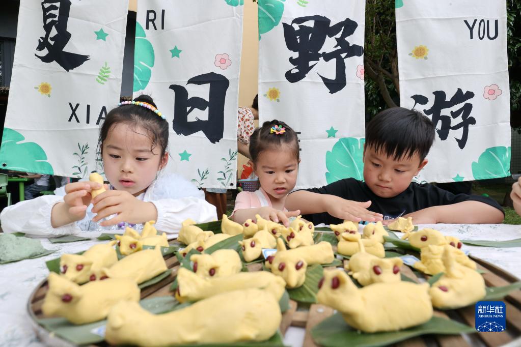 Buat arca nasi berbentuk anjing juga salah satu amalan Hari Lixia. Gambar ini menunjukkan murid-murid tadika di Huzhou, Zhejiang, membuat arca nasi anjing pada 5 Mei. (Xinhua/Xie Shangguo)