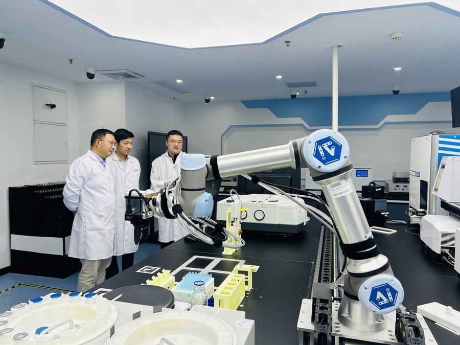 Foto yang diambil dengan telefon pintar ini menunjukkan sekumpulan penyelidik mengguna pakai peranti ahli kimia robotik pacuan AI di Universiti Sains dan Teknologi China di Hefei, provinsi Anhui, 10 November 2023. (Xinhua/Zhou Chang)