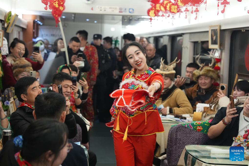 Seorang penari sedang membuat persembahan di dalam kereta api. (Xinhua/Wang Song)