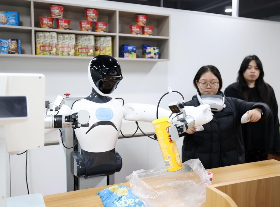 Seorang kakitangan melatih robot di pusat inovasi latihan persepsi digital taktil dan multimod kecerdasan terkandung di daerah Shijingshan, Beijing, ibu kota China, 17 Mac 2026. (Xinhua/Zhang Chenlin)
