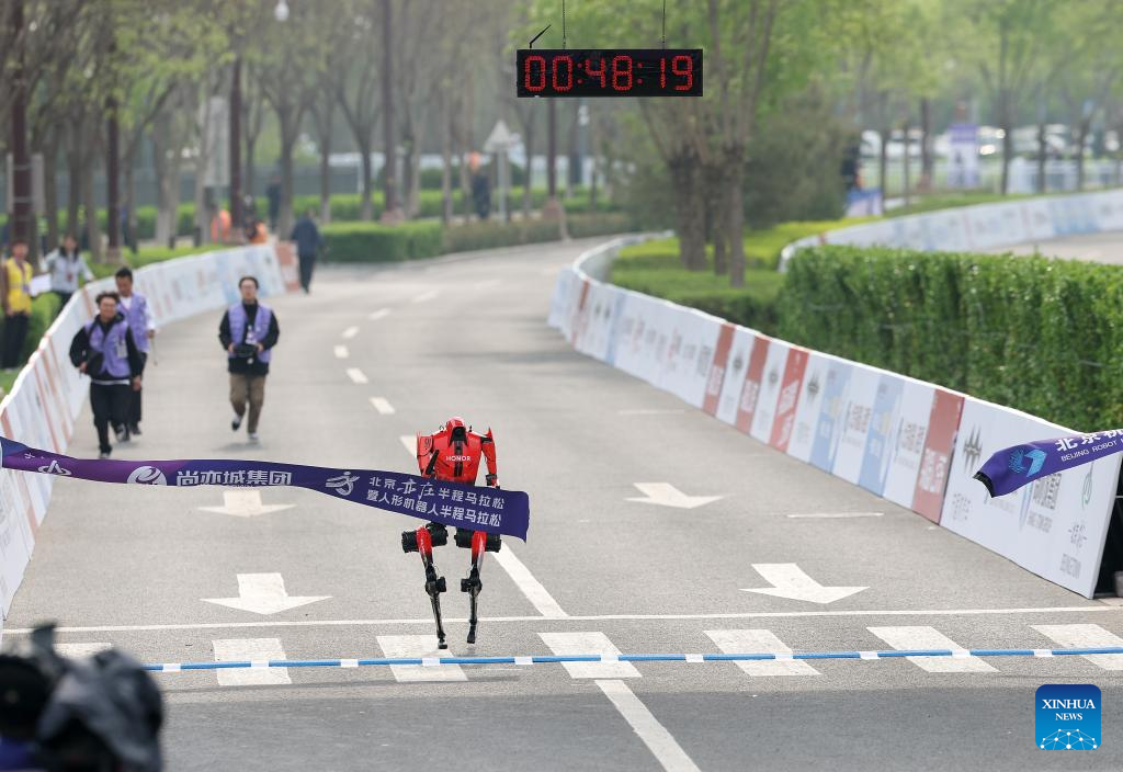 Robot manusia “Flash” yang mewakili Pasukan Jueyingchitu dalam kategori kawalan jauh, melintasi garis penamat pada separuh maraton E-Town Beijing dan separuh maraton robot manusia di Kawasan Pembangunan Ekonomi-Teknologi Beijing di tenggara Beijing, China, 19 April 2026. (Xinhua/Zhang Chenlin)