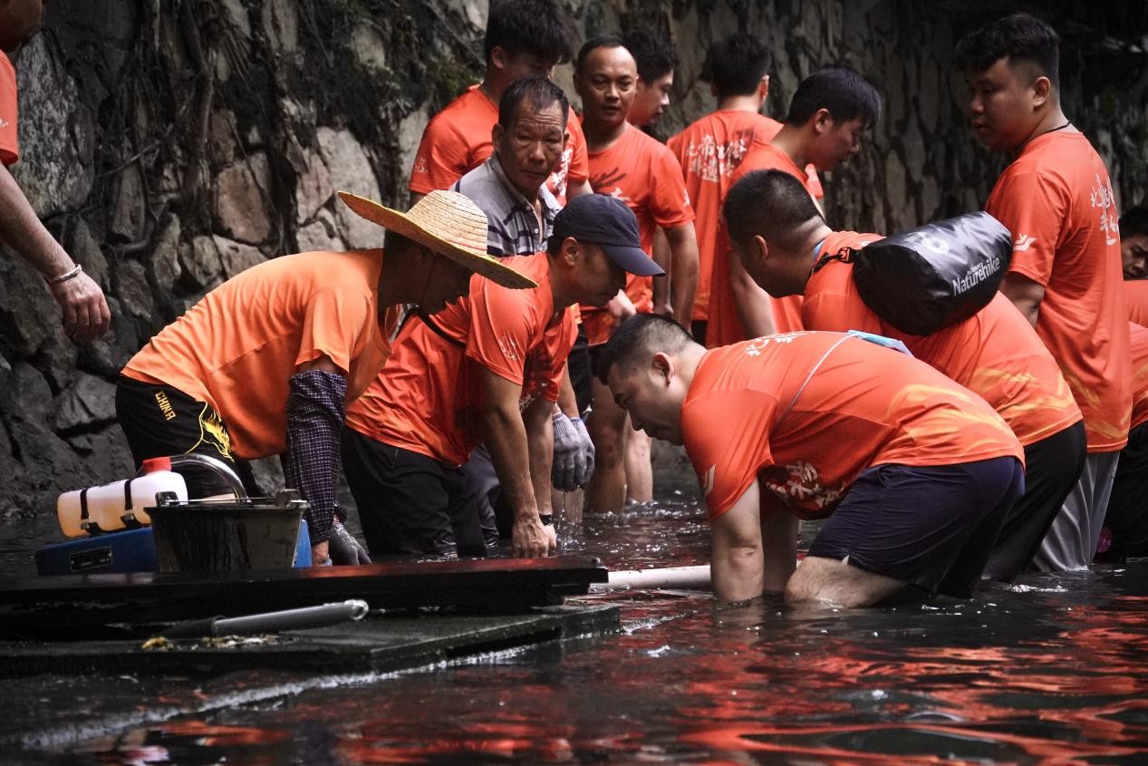 Penduduk kampung Yangji mengangkat bot naga. (People's Daily Online/Han Yuxuan)