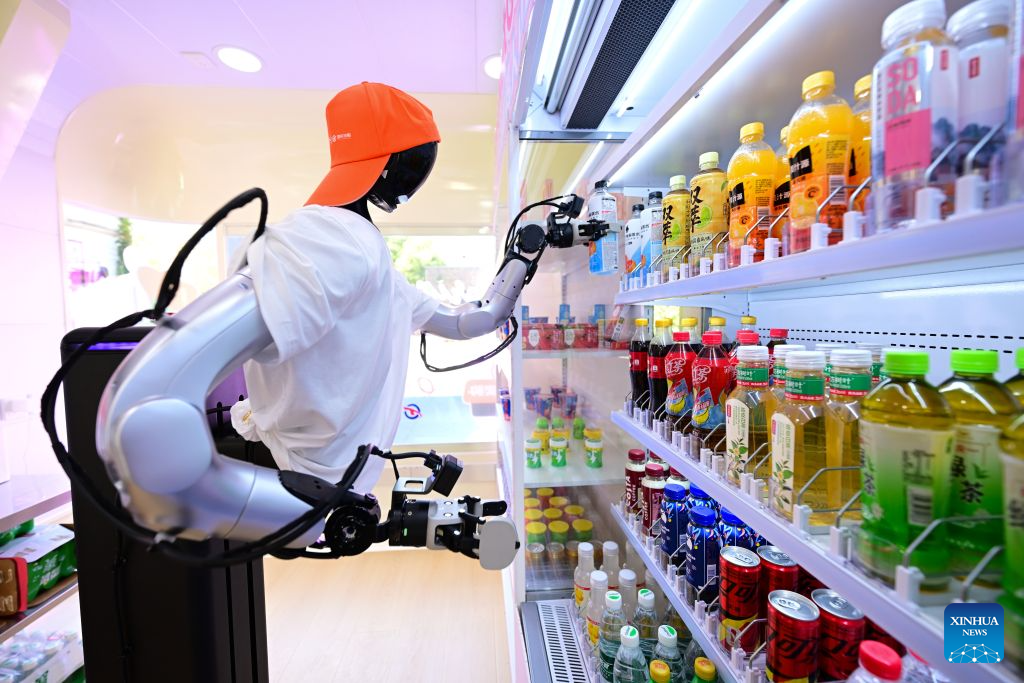 Sebuah robot mengambil sebotol minuman elektrolit dari rak di sebuah kedai robot pintar terkandung di Jalan Leijie, Hefei, provinsi Anhui, timur China, 26 Ogos 2026. (Xinhua/Zhou Mu)