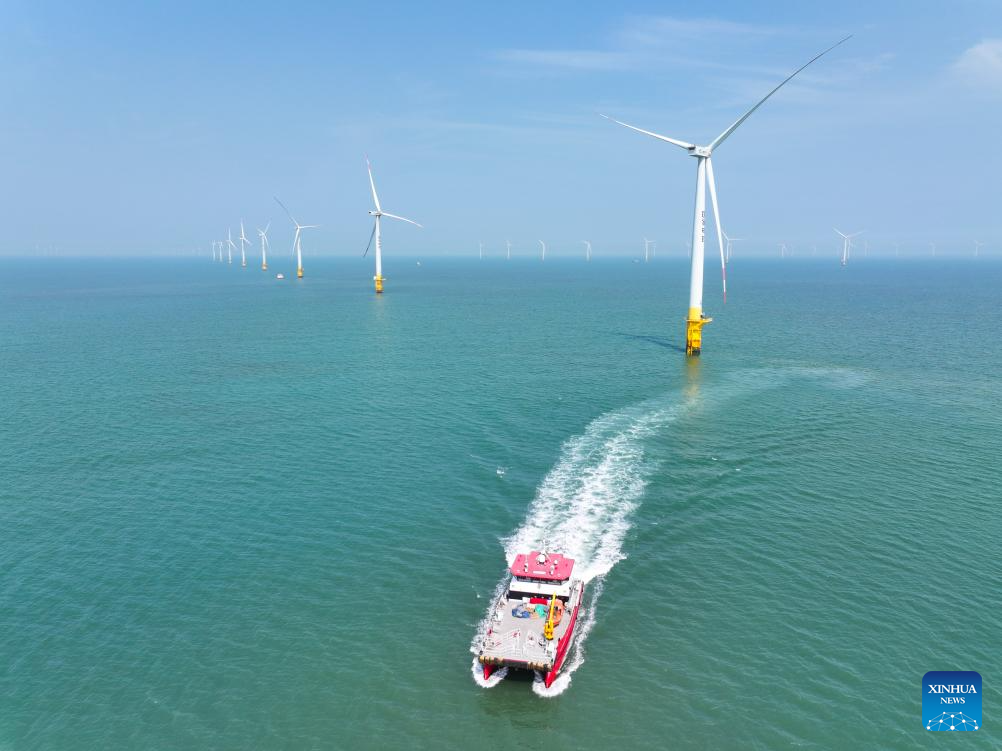 An aerial drone photo taken on June 10, 2026 shows a maintenance vessel sailing at an offshore wind farm in Rudong, east China's Jiangsu Province. (Photo by Xu Congjun/Xinhua)