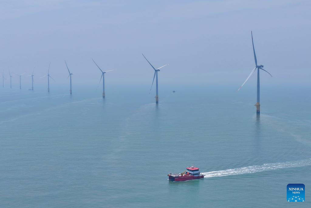 An aerial drone photo taken on June 10, 2026 shows a maintenance vessel sailing at an offshore wind farm in Rudong, east China's Jiangsu Province. (Photo by Xu Congjun/Xinhua)